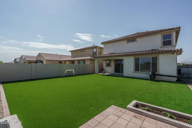 a view of house with backyard and entertaining space