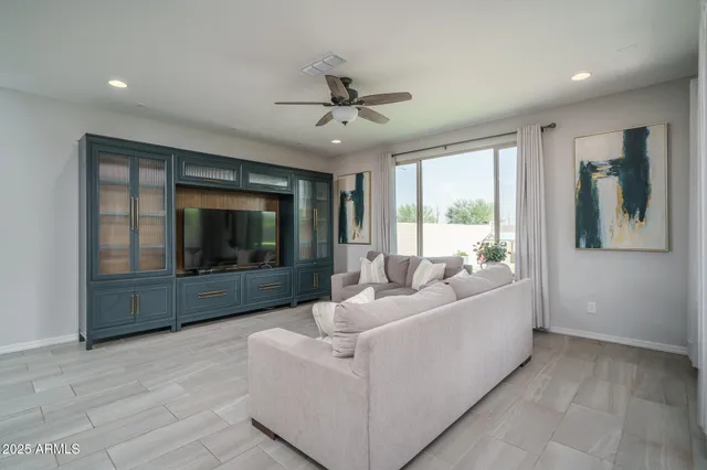 a living room with furniture and a large window with garden view