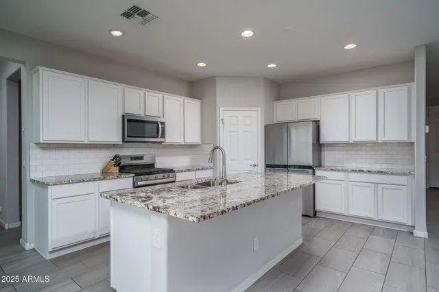 a living room with furniture and kitchen view