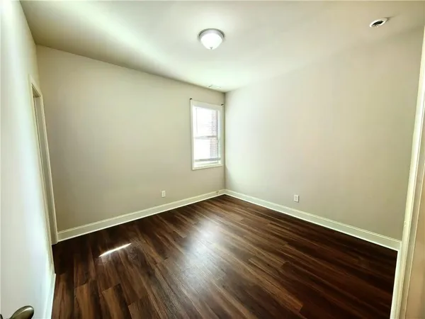 a bathroom with a sink a toilet a mirror and shower