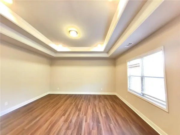 a spacious bathroom with a tub sink and mirror
