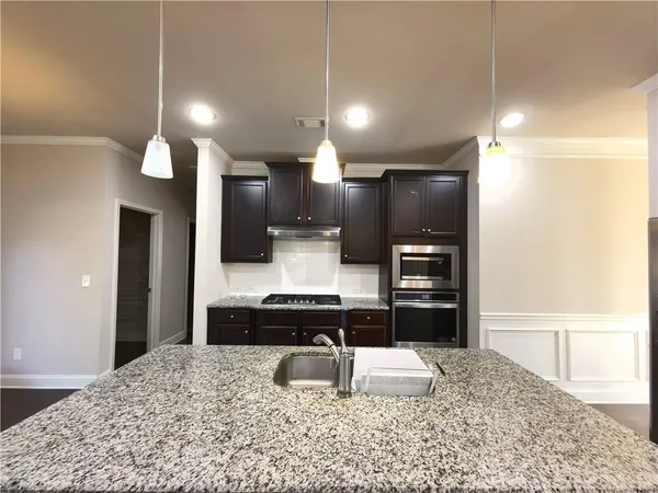 a kitchen with a stove and a refrigerator