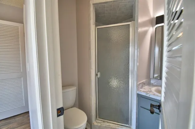 a bathroom with a granite countertop shower and a sink