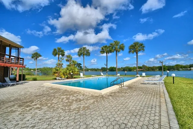 a view of a swimming pool and a yard