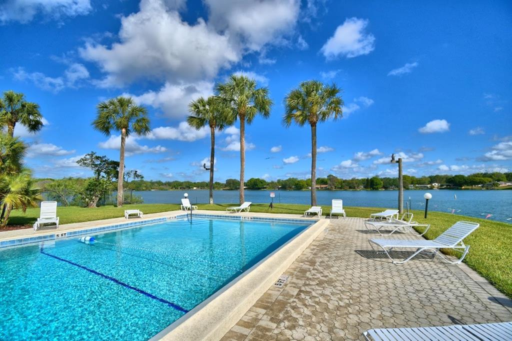 1920 East Edgewood Drive, Unit R8 Lakeland, FL 33803 - Photo 26 of 30 a view of swimming pool with a table and chairs