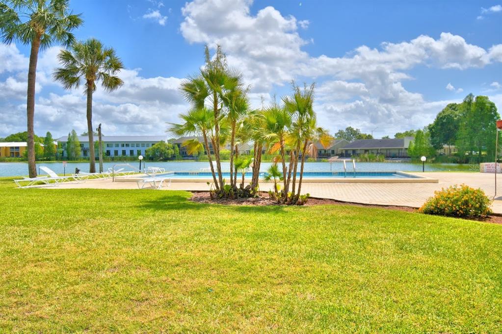1920 East Edgewood Drive, Unit R8 Lakeland, FL 33803 - Photo 27 of 30 a view of a swimming pool and a yard