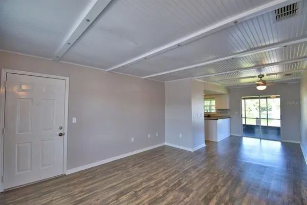 a view of interior space with wooden floor and windows