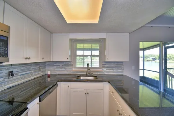 a kitchen with a sink a counter top space and a window
