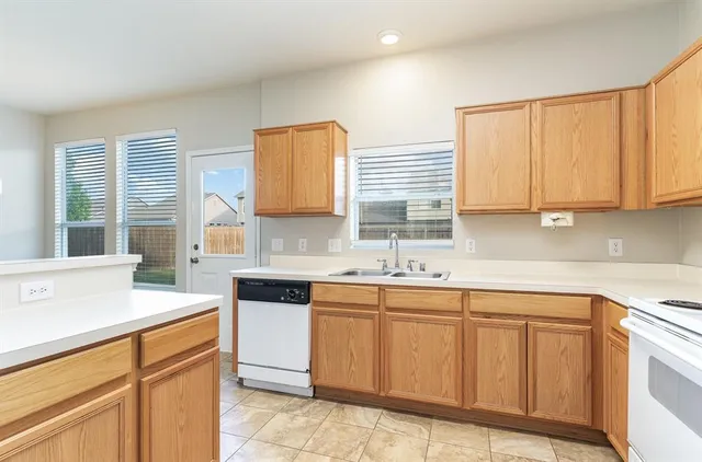 a kitchen with a sink stove and cabinets