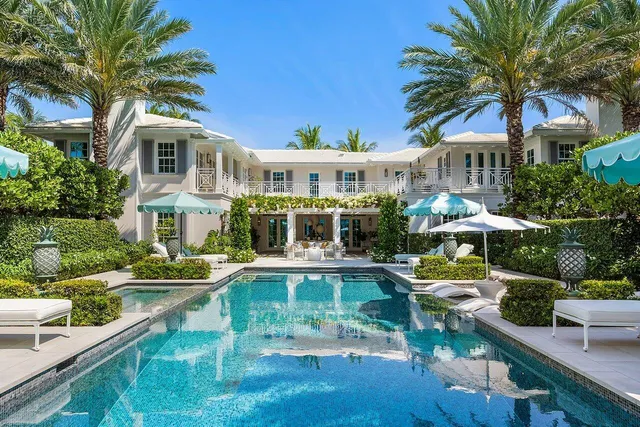 a front view of a house with swimming pool having outdoor seating