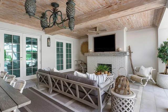 a living room with furniture a flat screen tv and a fireplace