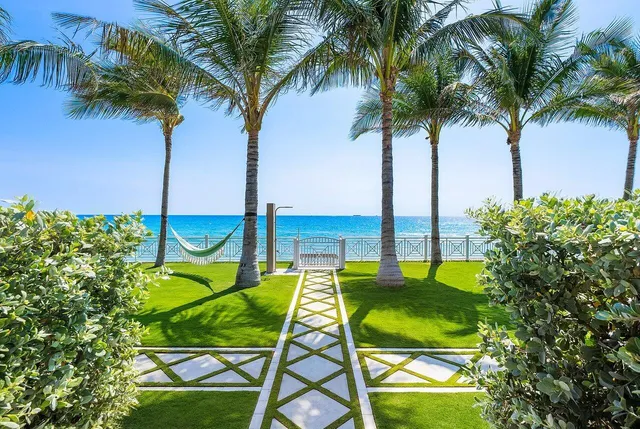 a view of a backyard with swimming pool and outdoor seating