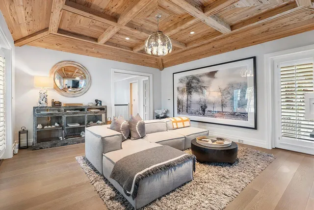 a living room with furniture a table and a large window