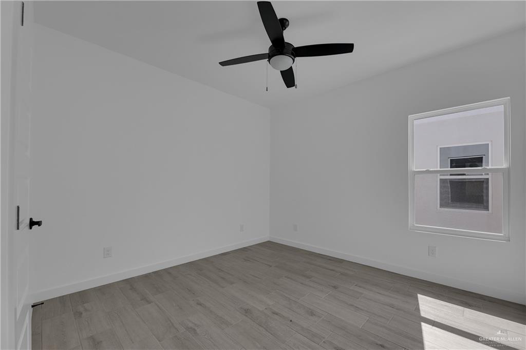 2509 Mockingbird Road, Unit B Weslaco, TX 78596 - Photo 7 of 11 Unfurnished room featuring ceiling fan and light hardwood / wood-style floors