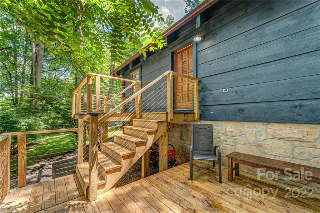 1305 Old Balsam Road Waynesville, NC 28786 - Photo 12 of 42 a view of wooden house with a bench