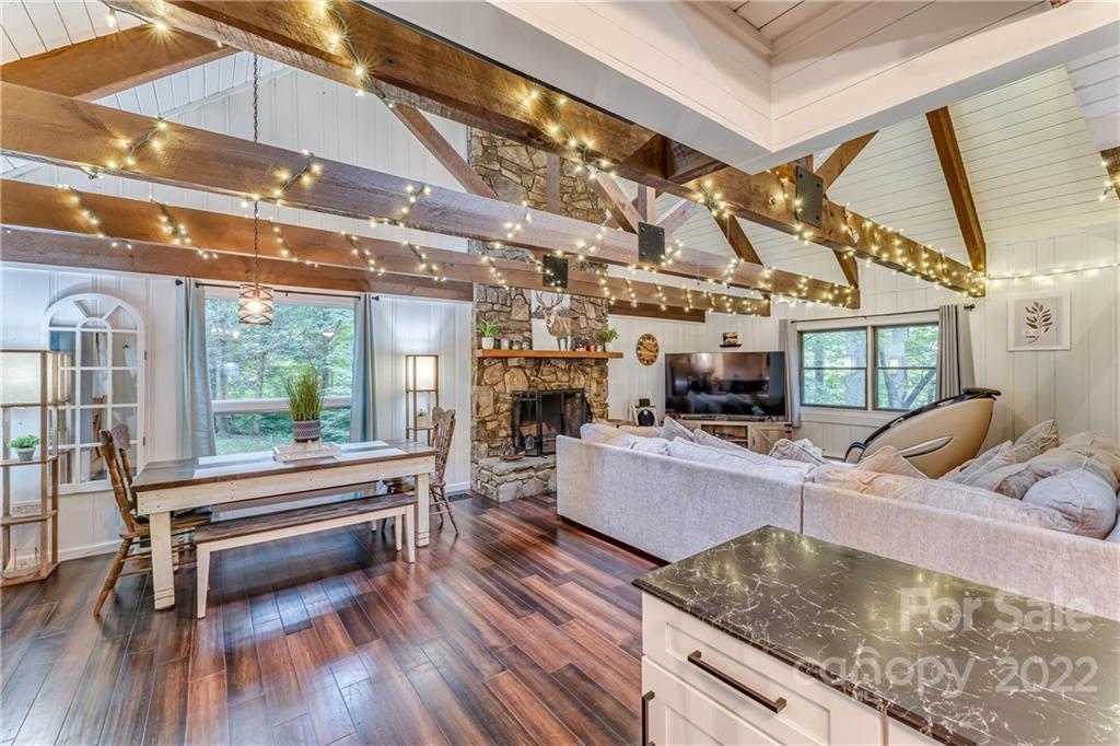 1305 Old Balsam Road Waynesville, NC 28786 - Photo 18 of 42 a kitchen with stainless steel appliances granite countertop a stove and cabinets with wooden floor