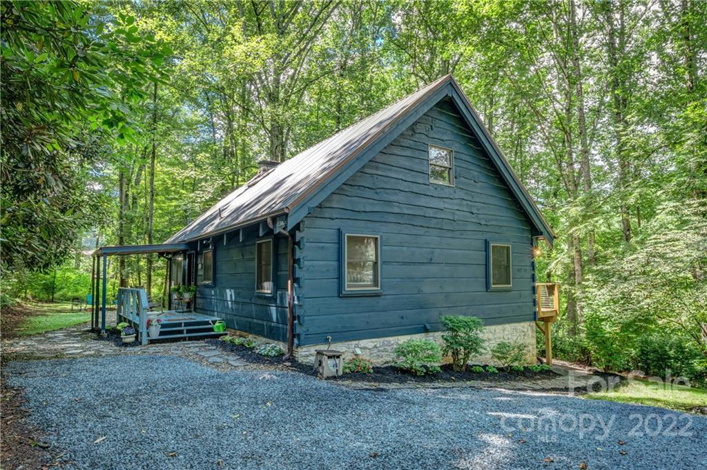 1305 Old Balsam Road Waynesville, NC 28786 - Photo 2 of 42 a view of a house that has large window and large tree