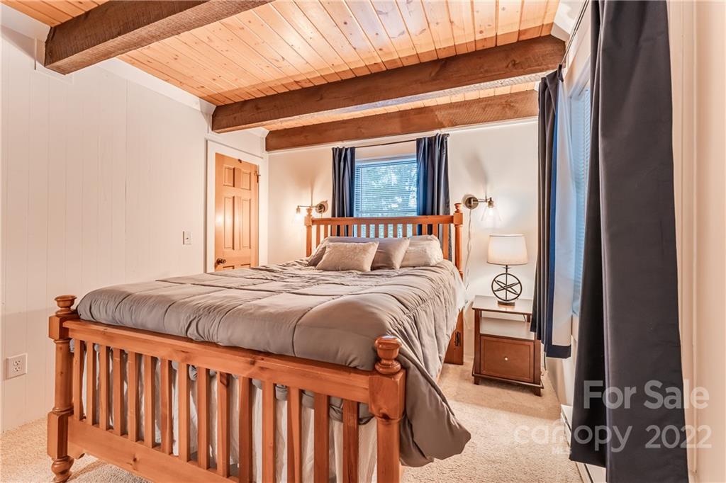 1305 Old Balsam Road Waynesville, NC 28786 - Photo 21 of 42 a bedroom with a bed and a window