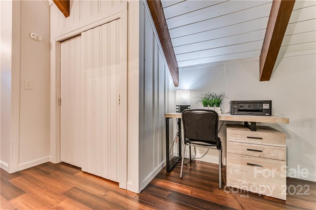 1305 Old Balsam Road Waynesville, NC 28786 - Photo 24 of 42 a view of a workspace with furniture and wooden floor