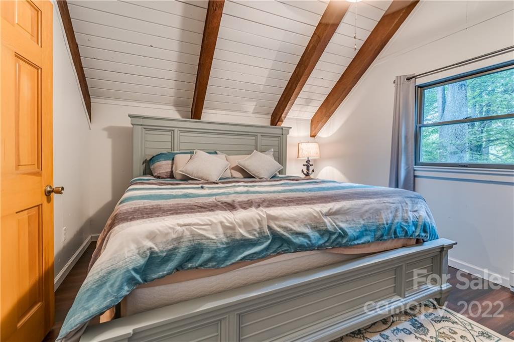 1305 Old Balsam Road Waynesville, NC 28786 - Photo 29 of 42 a bedroom with a bed and window