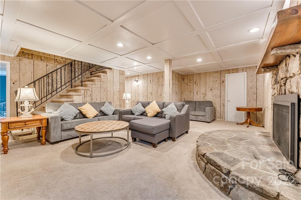 1305 Old Balsam Road Waynesville, NC 28786 - Photo 32 of 42 a living room with furniture a flat screen tv and a window