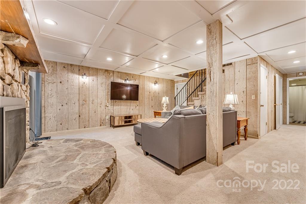 1305 Old Balsam Road Waynesville, NC 28786 - Photo 33 of 42 a living room with furniture and a flat screen tv