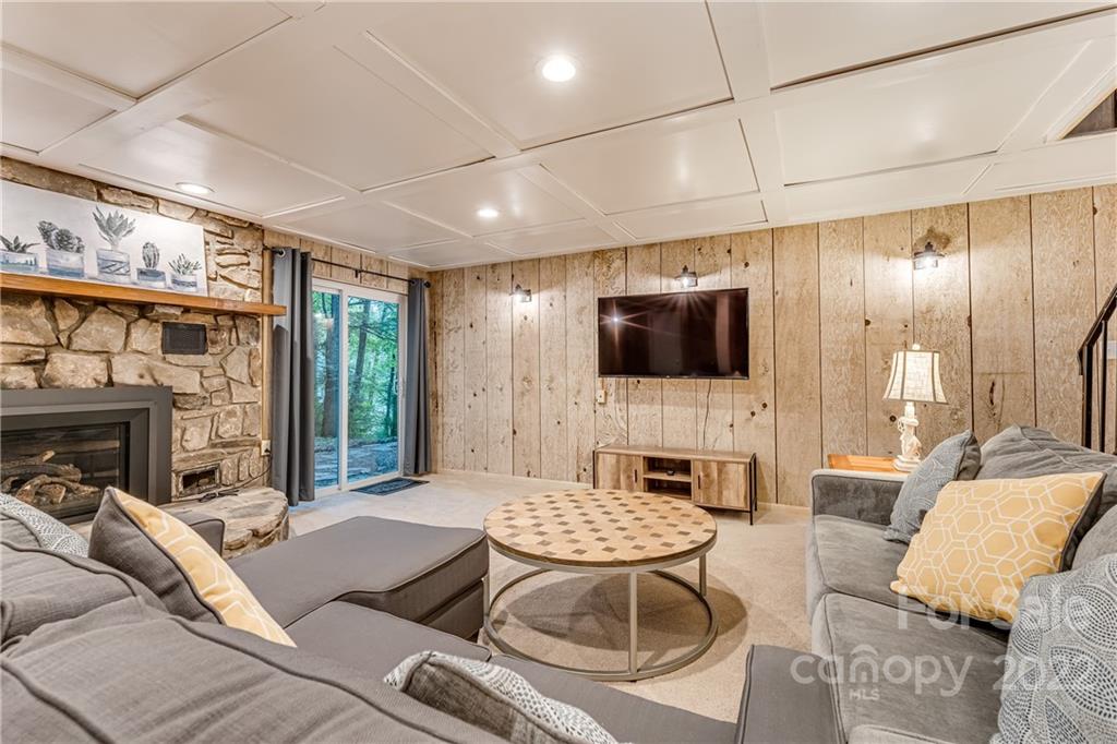 1305 Old Balsam Road Waynesville, NC 28786 - Photo 34 of 42 a living room with furniture and a flat screen tv