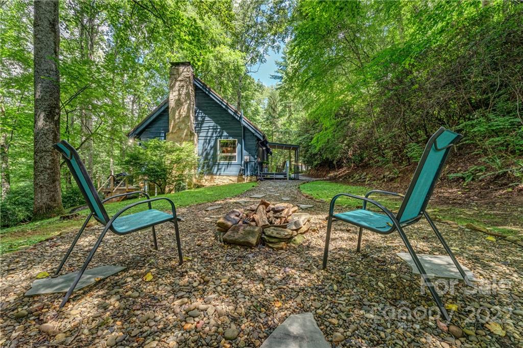 1305 Old Balsam Road Waynesville, NC 28786 - Photo 8 of 42 a view of a chair and table in backyard