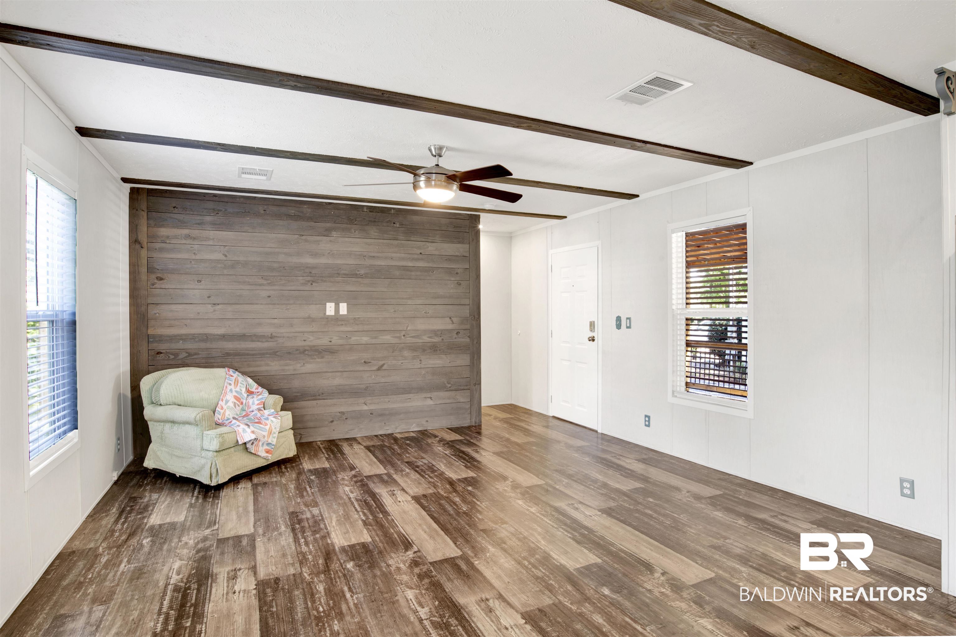 1411 Ridgewood Drive Lillian, AL 36549 - Photo 11 of 30 Unfurnished room with beam ceiling, ceiling fan, hardwood / wood-style floors, and crown molding