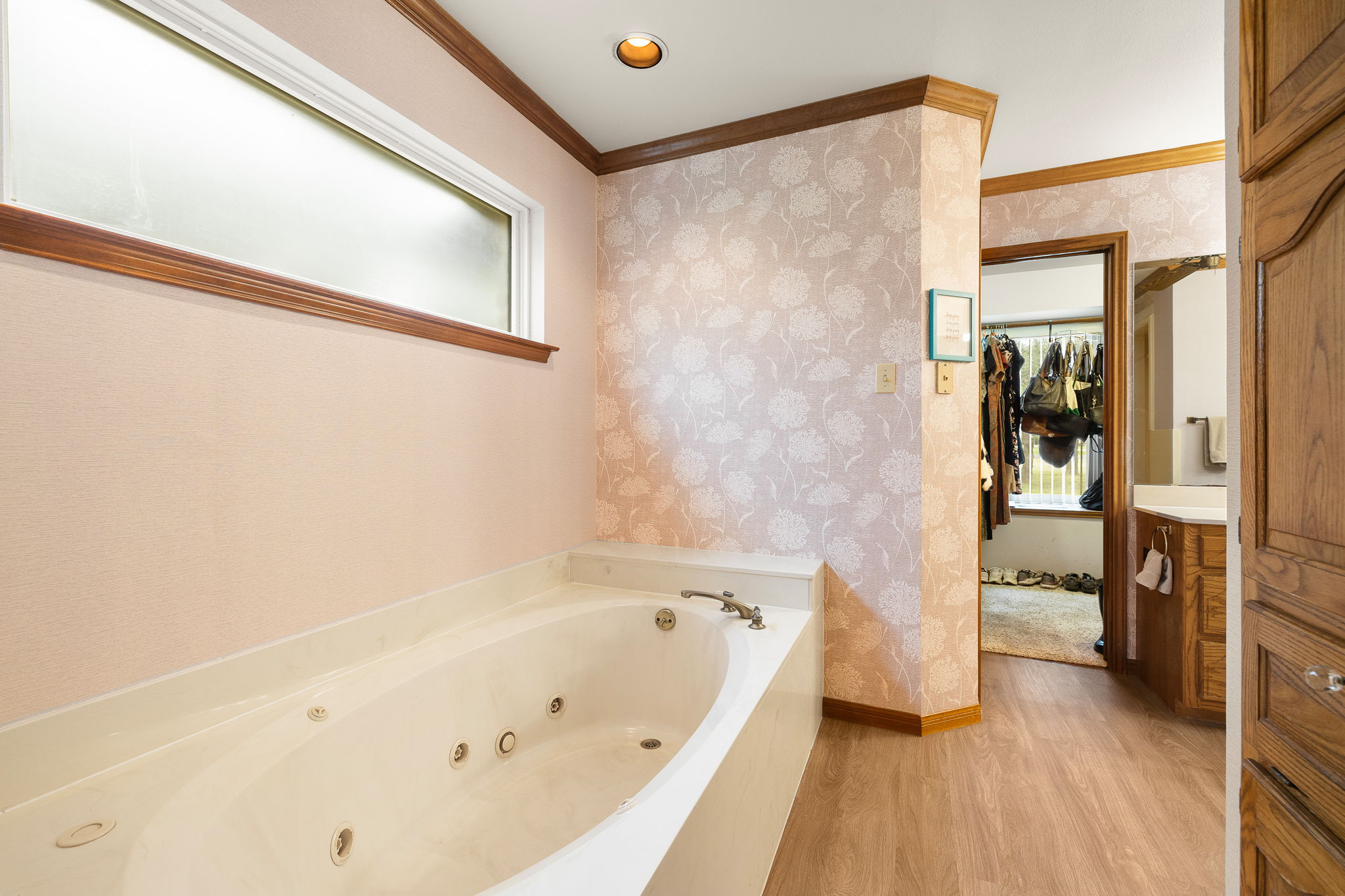 136 Valley View Road Georgetown, TX 78633 - Photo 21 of 40 The primary bathroom has newish LVP flooring, a large garden tub, two sinks, private toilet room with a window and a separate walk-in shower.