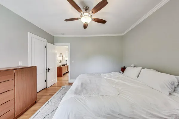 a bed room with a bed and a ceiling fan