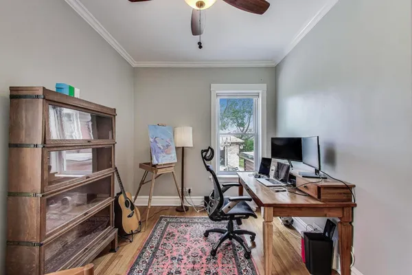 a view of a workspace with furniture and a window