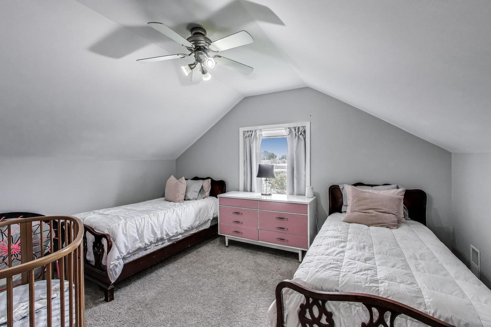 36 Touhy Avenue Park Ridge, IL 60068 - Photo 16 of 28 a bedroom with a bed and a chandelier