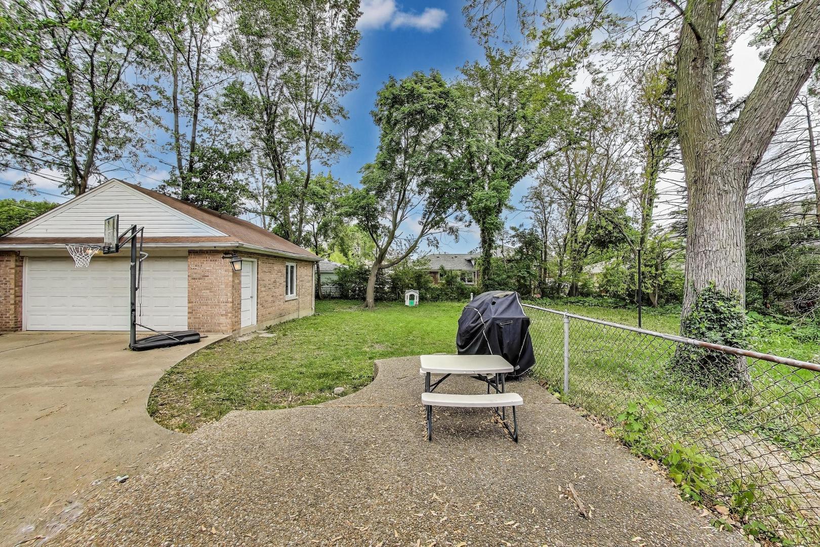 36 Touhy Avenue Park Ridge, IL 60068 - Photo 21 of 28 a view of a patio with a table chairs and a yard