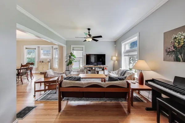 a living room with furniture a flat screen tv and a large window