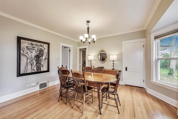 a view of a dining room with furniture wooden floor and chandelier