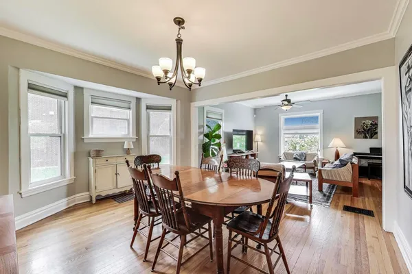 a view of a dining room with furniture wooden floor and chandelier