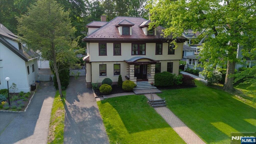 a front view of a house with garden