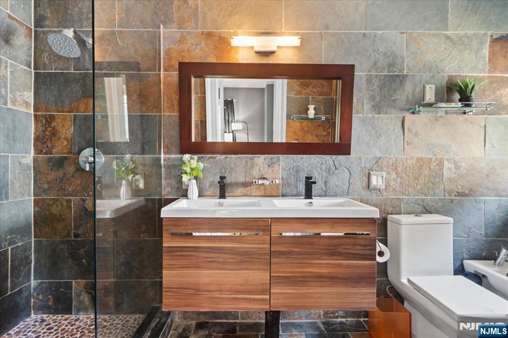 12 Harrison Avenue Montclair, NJ 07042 - Photo 12 of 34 a bathroom with a sink a toilet and shower