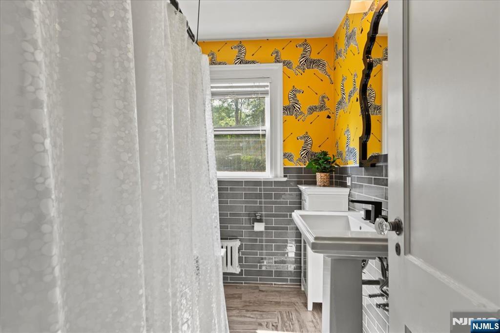 12 Harrison Avenue Montclair, NJ 07042 - Photo 17 of 34 a bathroom with a sink and a mirror