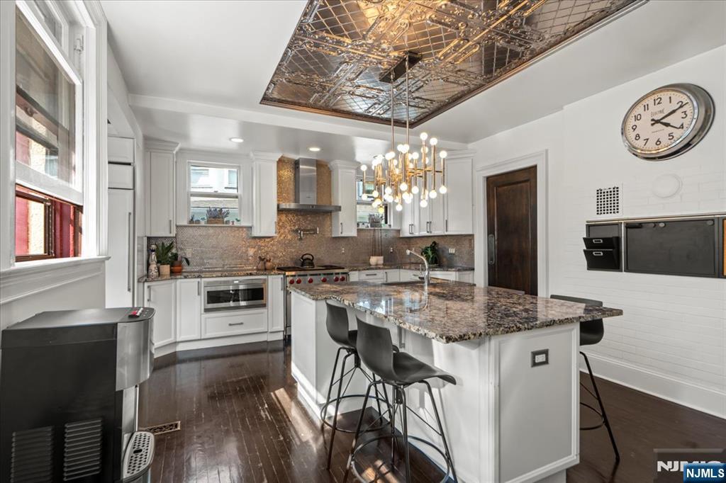12 Harrison Avenue Montclair, NJ 07042 - Photo 3 of 34 a kitchen with kitchen island granite countertop a sink cabinets a refrigerator and a stove