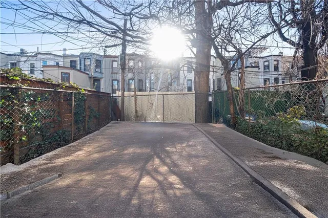 a view of a yard with wooden fence