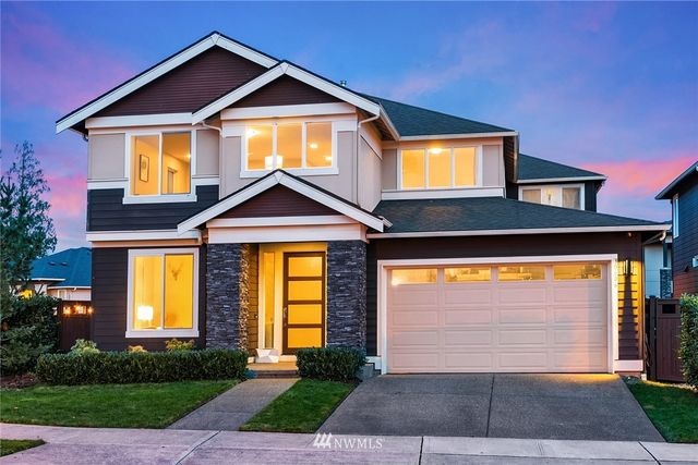 a front view of a house with yard