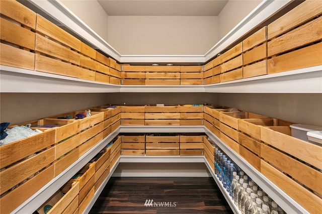 a dining room with furniture a chandelier and wooden floor