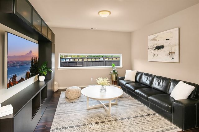 a living room with furniture a rug and a wall painting