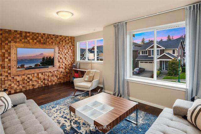 a bed sitting in a spacious bedroom next to a window