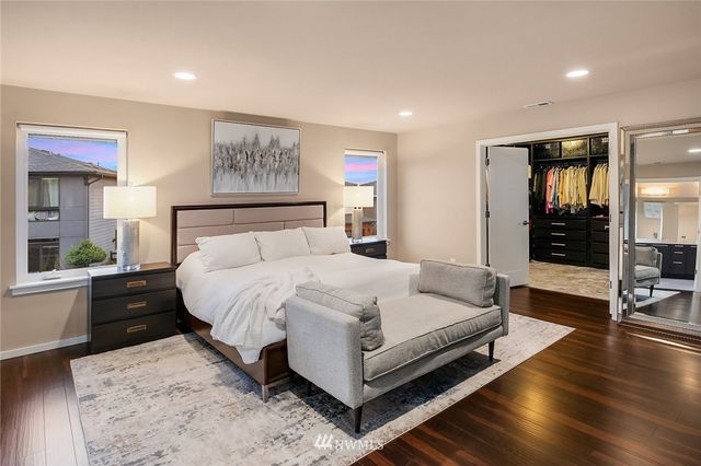 a bathroom with a double vanity sink a mirror and a bathtub