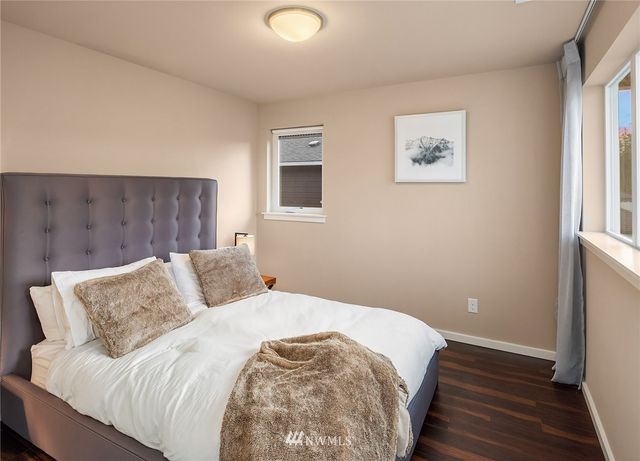 a view of a hallway with wooden floor and entryway