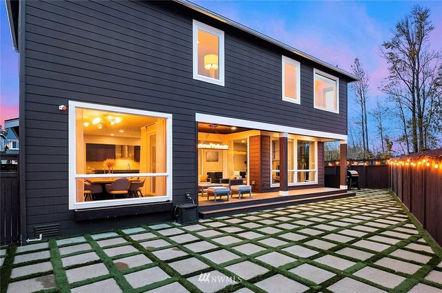 an aerial view of multiple houses with a yard