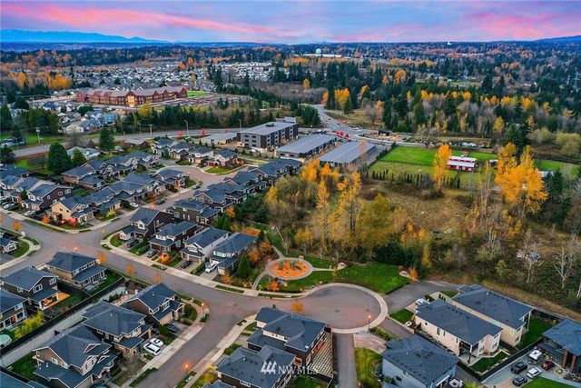 a living room with furniture rug and lamp